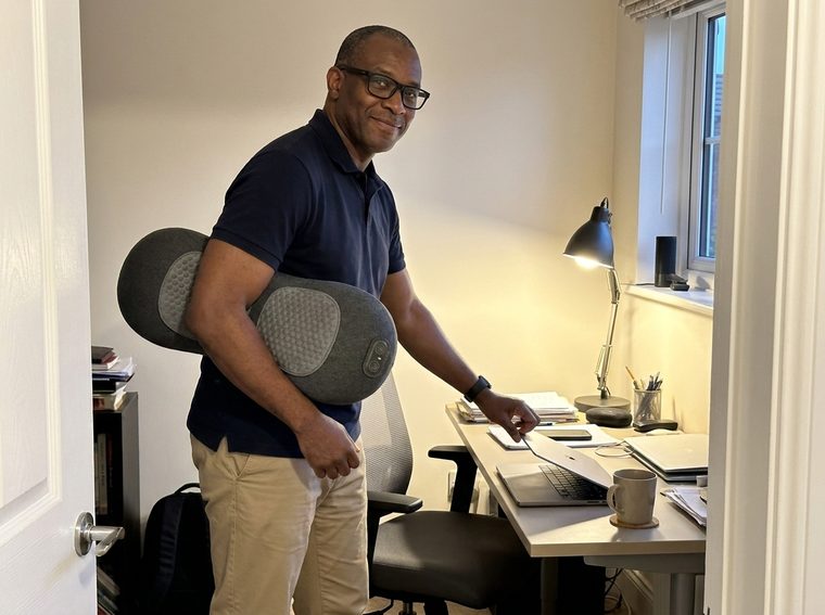 John D. in his home office, carrying the Lumbean past his desk.